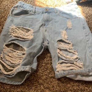 Ripped blue Jean shorts (shows skin on one side)